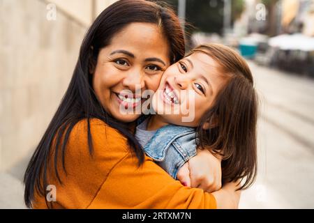 Bonne mère d'Asie du Sud-est avec sa fille s'amuser dans le centre-ville - belle famille à l'extérieur Banque D'Images