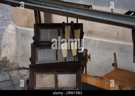 Boulangerie Trdelnik dans la rue de Prague près de la tour du pont Charles, République tchèque. Cuisine traditionnelle tchèque nationale sucrée remplie de crème glacée avec va Banque D'Images