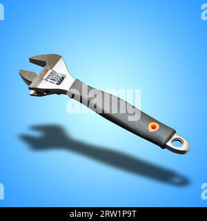 Clé réglable avec outil de mesure sur fond dégradé bleu Banque D'Images