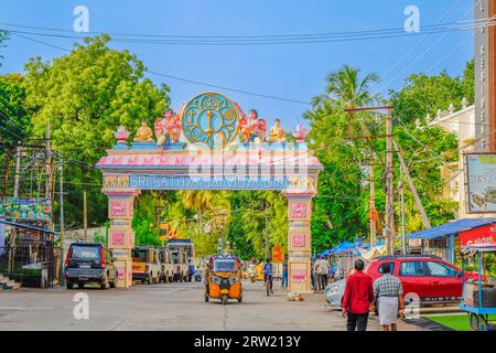 Puttaparthi, Inde - septembre 01 2023 : porte sur la route de Puttaparthi avec des skulptures d'angle, des gens et un pousse-pousse Banque D'Images