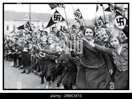 La Ligue nazie des filles allemandes d'Anschluss 1930 agite des drapeaux nazis en swastika pour soutenir et féliciter l'annexion allemande de l'Autriche. Vienne, Autriche, mars 1938. L'armée du chef nazi Adolf Hitler est entrée dans les limites de la ville de Vienne, en Autriche, le 14 mars 1938 pour annexer Austria Anschluss Banque D'Images