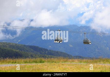 deux cabines de télésiège pour transporter les randonneurs vers les hautes montagnes sans effort en été Banque D'Images