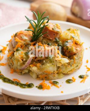 Salade de saucisses avec pommes de terre, oignon et pesto vert. Banque D'Images