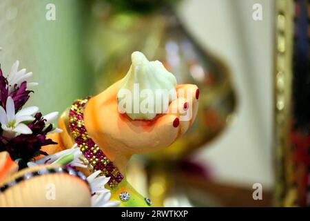 modak, prashadam du Seigneur Ganesha. Ganpati bappa tient son doux modak préféré dans sa main. Gros plan de la main de ganesh tenant modak Banque D'Images