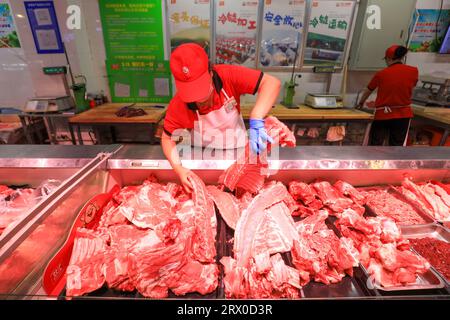 Comté de Luannan, Chine - 10 août 2023 : le personnel du supermarché organise des produits à base de viande. Banque D'Images