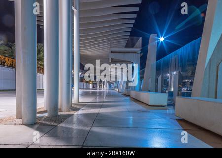 Promenade publique à Malaga, Parmeral de las Sorpresas à la fin de la nuit dans les couleurs des lumières nocturnes de la ville. Architecture urbaine moderne, Malaga. Banque D'Images