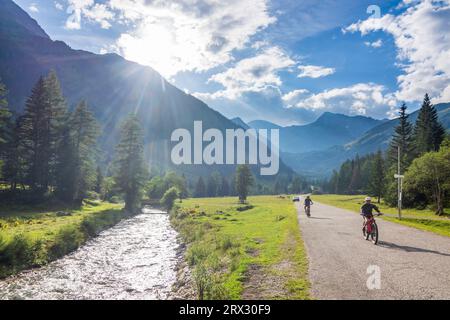 Mallnitz : Vallée de Mallnitzbach, ruisseau Mallnitzbach, cyclistes, Parc National du Haut Tauern dans le Parc National Hohe Tauern, Kärnten, Carinthie, Autriche Banque D'Images