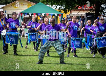 Danny Henry, artiste de danse noire, danse au rythme du groupe de tambours Batida Rio Samba lors de la Journée de sensibilisation au handicap 2023 à Warrington Banque D'Images