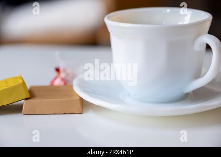 Tasse de café avec des morceaux de chocloate sur la table du salon Banque D'Images