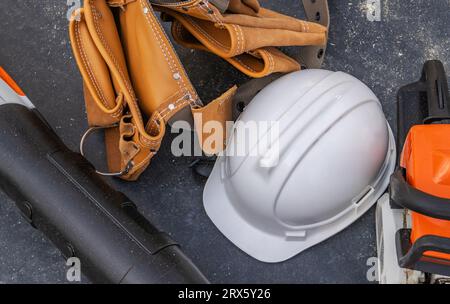 Photo de gros plan sur le casque de chantier et la ceinture d'outils. Thème de l'industrie de la construction Banque D'Images