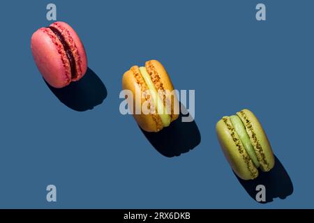 Macarons multicolores sur fond bleu Banque D'Images