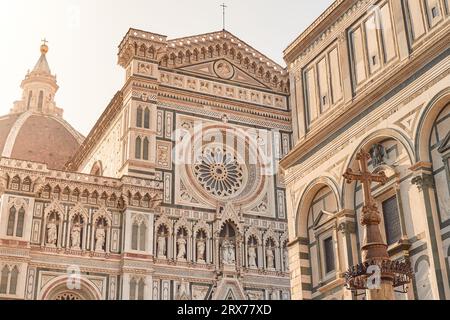 Détail de la cathédrale de Santa Maria del Fiore à Florence à l'aube avec Crucifix au premier plan et détail du baptistère de San Giovanni sur t Banque D'Images