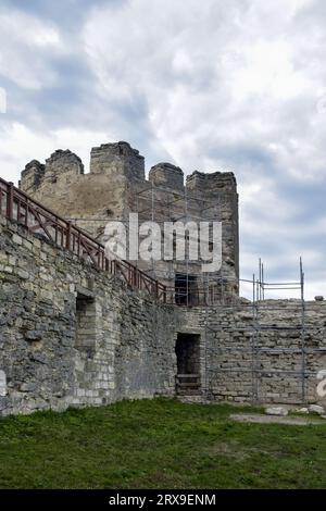 Réalisation de travaux de restauration dans l'ancienne forteresse médiévale. Un échafaudage métallique est installé à côté de l'ancien mur pour travailler en hauteur. Espace de copie. Sél Banque D'Images