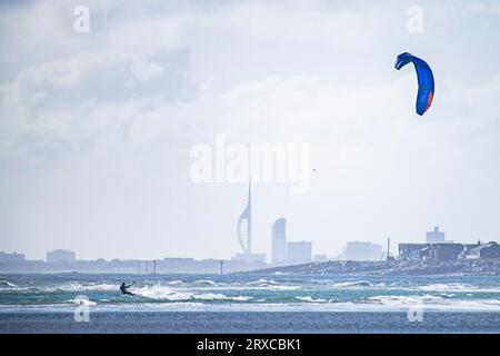 Kitesurf sur la plage de West Wittering avec Portsmouth et la Tour Spinnaker au loin Banque D'Images