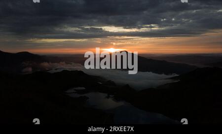 Lever du soleil depuis le sommet de YR Wyddfa / Snowdon regardant à travers Snowdonia, pays de Galles Banque D'Images