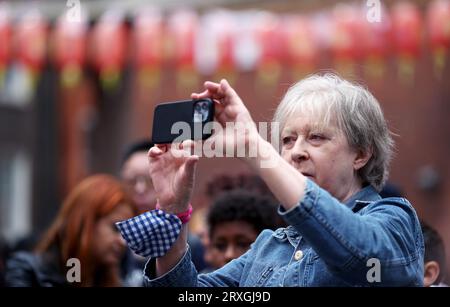 (230925) -- LONDRES, 25 septembre 2023 (Xinhua) -- Une femme prend des photos lors d'un spectacle pour la célébration du Festival chinois de la mi-automne à Londres, Grande-Bretagne, le 24 septembre 2023. Un spectacle pour la célébration du Festival chinois de la mi-automne a été organisé dans le Chinatown de Londres dimanche après-midi, impressionnant beaucoup avec des spectacles mettant en vedette la culture et l'art chinois Commençant par une danse du lion, le spectacle a captivé une foule énorme dans le quartier animé avec une variété de programmes, y compris des danses de style chinois, des performances instrumentales, des chansons, des danses de marionnettes, et acrobaties. Le festival annuel de mi-automne, Banque D'Images