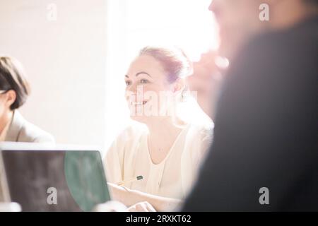 Mature businesswoman smiling during meeting in office Banque D'Images