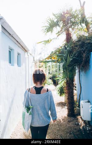 Femme portant un sac de légumes Banque D'Images