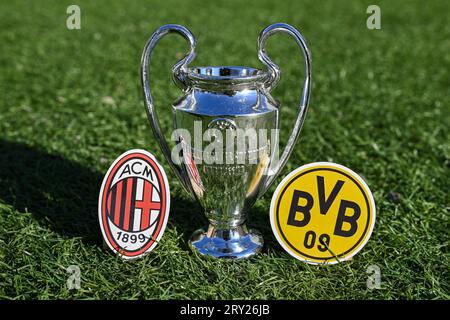27 septembre 2023, Londres, Royaume-Uni. La coupe de la Ligue des champions de l'UEFA et les emblèmes des clubs de football du Borussia Dortmund et de l'AC Milan sur le gree Banque D'Images