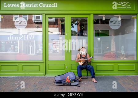 Un Street Entertainer habillé en pirate avec Un perroquet jouet jouant dans The High Street, Lewes, East Sussex, Royaume-Uni. Banque D'Images