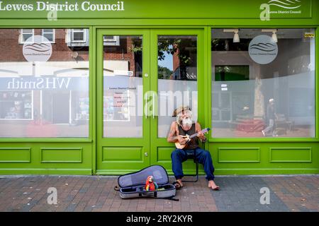 Un Street Entertainer habillé en pirate avec Un perroquet jouet jouant dans The High Street, Lewes, East Sussex, Royaume-Uni. Banque D'Images