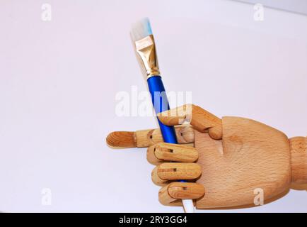 Main d'un robot peignant avec un pinceau. Banque D'Images