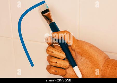 Main de robot tenant un pinceau. Banque D'Images