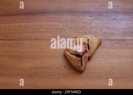 Hamantash (Ozen Haman), une pâtisserie juive ashkénaze en poche triangulaire traditionnellement consommée pendant les vacances Pourim. Espace négatif, espace texte vide Banque D'Images