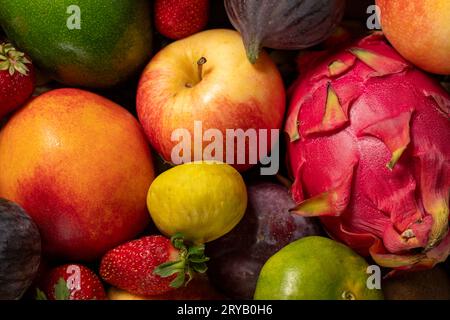 Gros plan de fond de fruits colorés frais. Mélange de fruits. Gros plan. Raisin, figue, fraise, pomme, poire, kiwi, pêche. Vue de dessus Banque D'Images