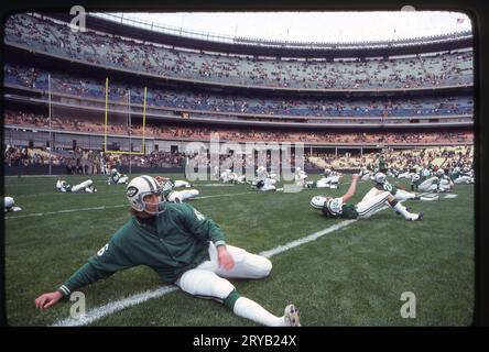 Une photo de 1978 des Jets de New York qui s'étirent et s'échauffent avant un match de football de la NFL au Shea Stadium à Flushing, Queens, New York. Le joueur au premier plan est la sécurité, Ken Schroy. Banque D'Images