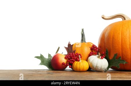 Joyeux Thanksgiving. Citrouilles, feuilles et baies sur la table en bois sur fond blanc. Espace pour le texte Banque D'Images