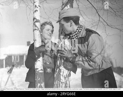 Hiver dans les années 1940 Un jeune couple profite de ses vacances d'hiver, et ils portent les vêtements de mode d'hiver typiques des années 1940 Suède février 1940. Photo Kristoffersson Ref 68-9 Banque D'Images