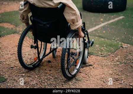 Femme handicapée assise en fauteuil roulant dans le parc. Photo de haute qualité Banque D'Images