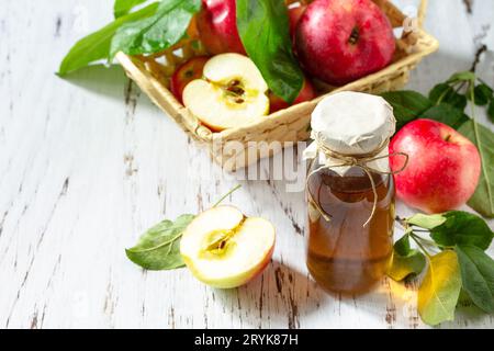 Aliments biologiques sains. Vinaigre de pomme, une bouteille de vinaigre de cidre de pomme sur une table rustique. Copier l'espace. Banque D'Images