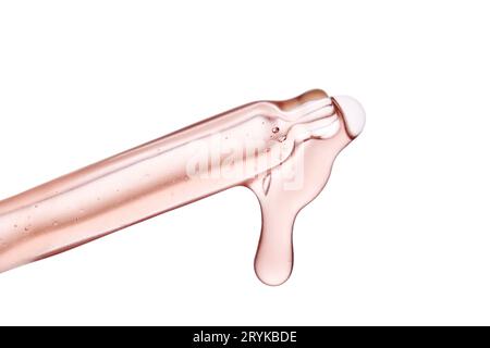 Pipette avec un gros plan cosmétique rose visqueux. Banque D'Images