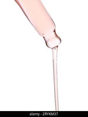Pipette avec un gros plan cosmétique rose visqueux. Banque D'Images