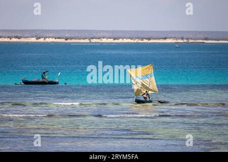 Beau paysage d'un bateau de pêche coloré et pêcheur naviguant sur une mer calme sous le soleil chaud de Madagascar Banque D'Images