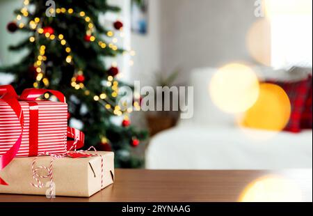 Arrière-plan de Noël, nouvel an avec espace de copie. Surface de table en bois vide, composition en sapin de Noël ornée de défocused, lumière de bokeh étincelante Banque D'Images