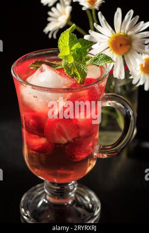 Limonade gazéifiée avec des tranches de fraise et menthe avec des fleurs Banque D'Images