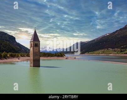 Le clocher à Reschensee et famille (Italie). Banque D'Images