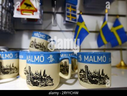 Tasses Malmö et drapeaux suédois exposés dans une boutique de souvenirs à Malmö, en Suède. Banque D'Images