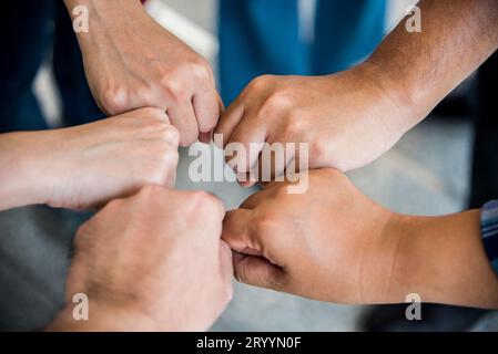 Close up Vue de dessus des jeunes faisant fist bump par les mains ensemble. Les gens d'affaires et de concept. L'unité et de l'équipe thème. Banque D'Images