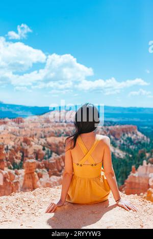 Femme randonneuse à Bryce Canyon se reposant profitant de la vue dans un magnifique paysage naturel avec des hoodoos, des pinacles et des flèches rocheuses formatio Banque D'Images