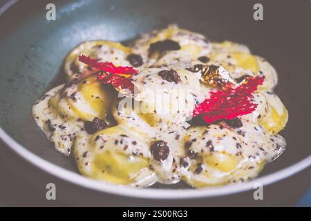 Raviolis truffe avec sauce à la crème française à la truffe, fromage italien Parmiggiano Reggiano, purée de truffe italienne et huile de dentelle de truffe Banque D'Images