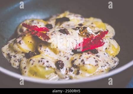 Raviolis truffe avec sauce à la crème française à la truffe, fromage italien Parmiggiano Reggiano, purée de truffe italienne et huile de dentelle de truffe Banque D'Images