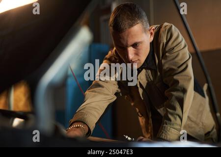 Mécanicien professionnel effectuant des diagnostics dans le service de voiture Banque D'Images
