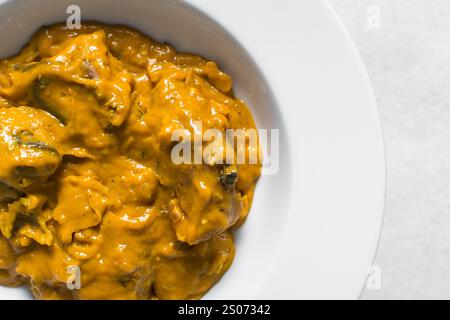 Vue aérienne de la soupe d'owo nigériane avec poisson et bœuf dans une assiette blanche, vue de dessus de la soupe d'oghwo dans une grande assiette Banque D'Images