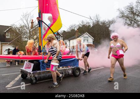 Windlesham, Surrey. Jeudi 26 décembre 2024. Les concurrents habillés en Barbies participent à la course annuelle de Windlesham Pram Day. L'événement caritatif qui a commencé en 1967 voit les coureurs compléter un parcours de 3,5 miles à travers le village de Windlesham dans le Surrey. Crédit : Katie Collins/Alamy Live News Banque D'Images