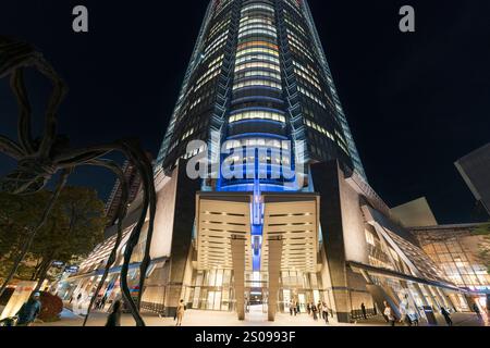 La tour Mori à Roppongi Hills. Point de vue à angle bas regardant directement de l'entrée au sommet de la tour éclairée la nuit. Banque D'Images