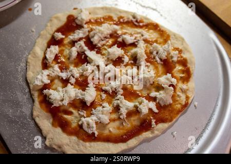 Pizza maison Assemblée avec sauce tomate et fromage frais Banque D'Images